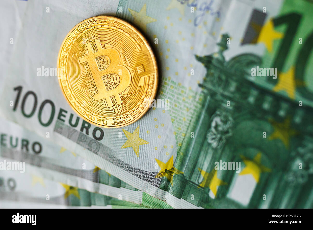 Virtual Money Golden Bitcoin On Hundred Euro Bills Background - 